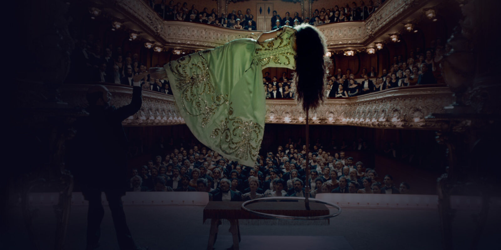 Men making a woman levitate on a theater stage
