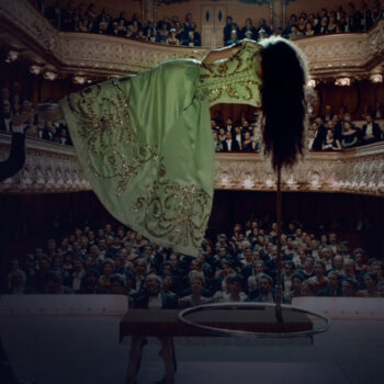 Men making a woman levitate on a theater stage