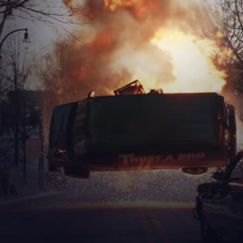 Flaming van sideways in the air