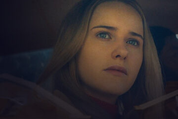 Close-up of a woman's face through the a car glass
