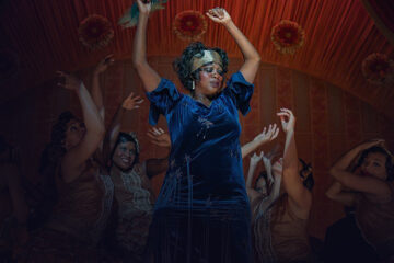 Women dancing with their hands in the air