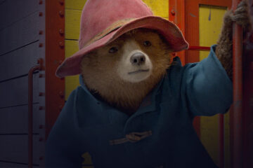 Paddington Bear clinging to the outside of a train
