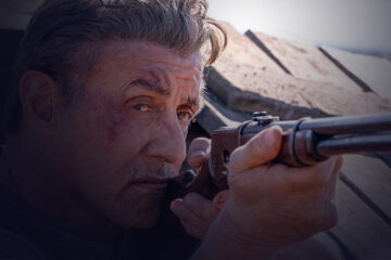 Close-up of a man targeting something with his gun