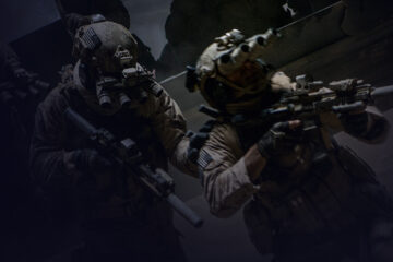 Three armed military men