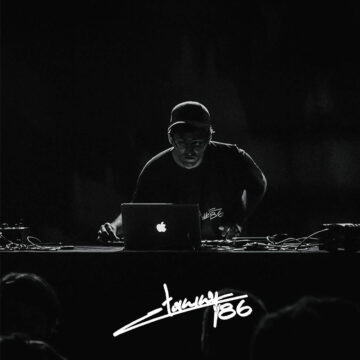 Artist Tommy 86 performing and mixing music on a laptop