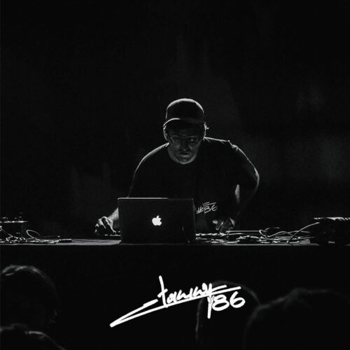 Artist Tommy 86 performing and mixing music on a laptop