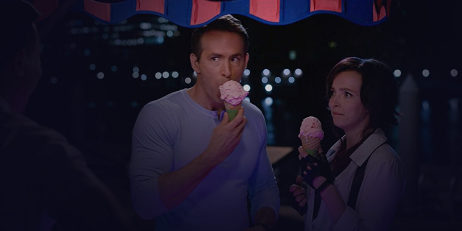 Medium shot of man and woman eating their cone ice cream